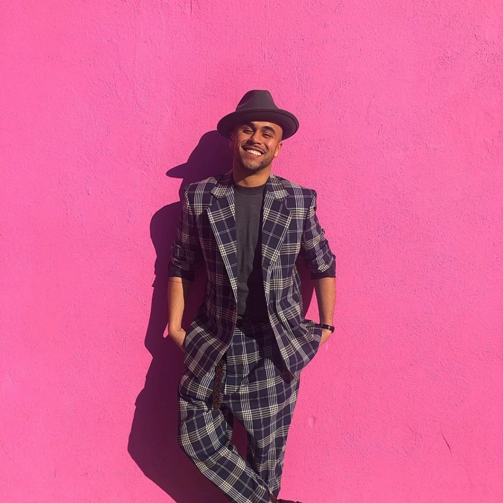 Sisco Gomez standing in front of a pink background