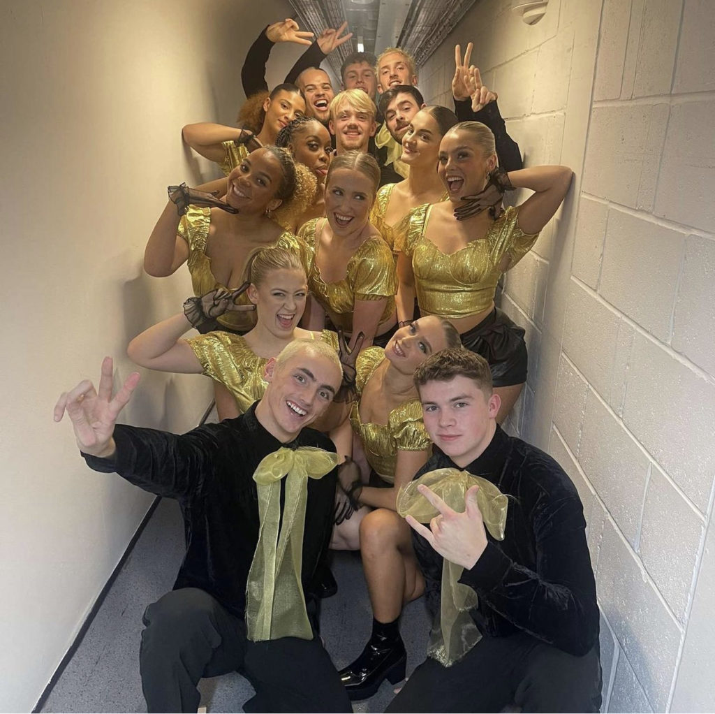 Students perform with Adam Lambert on the National Lottery’s New Year’s Eve Big Bash