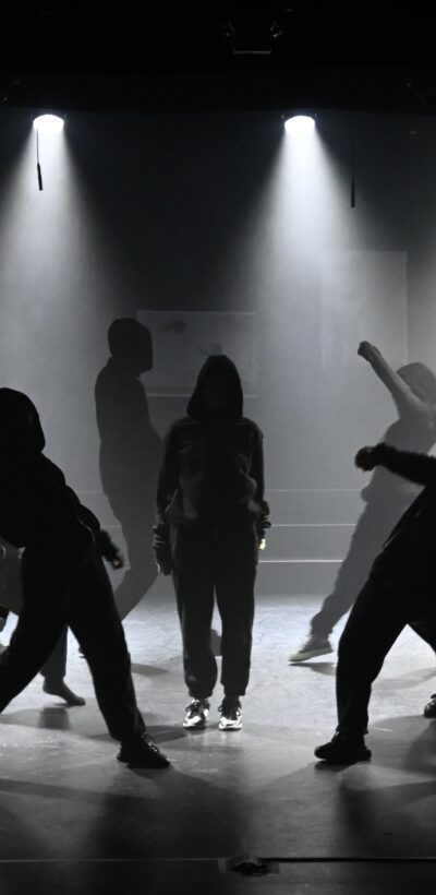 Black and white silhouette of students performing