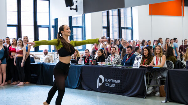 A student dances for the agent panel