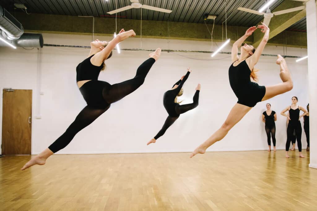 Student mid air using a jump technique in dance
