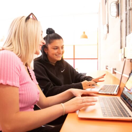 Performers College students working together on a laptop