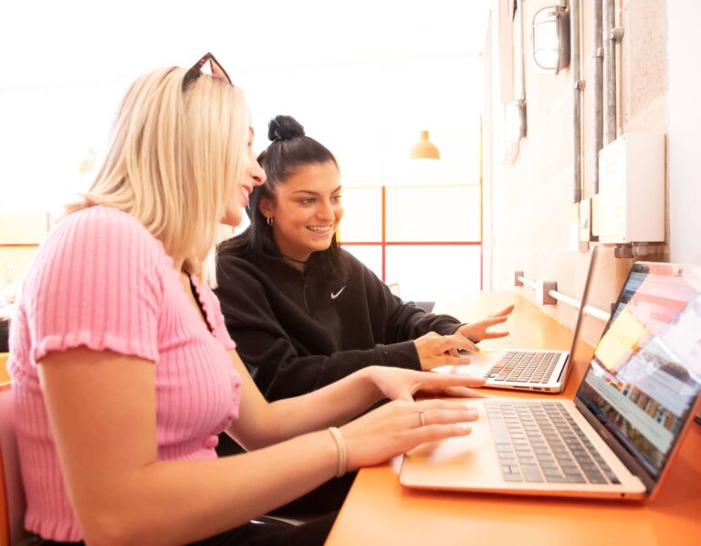 Performers College students working together on a laptop